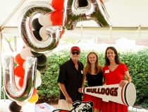 Photo of three people, with props