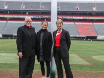 photo of three people on field