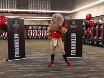 photo of mascot with banners in dressing room