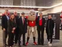 photo of people with mascot in dressing room