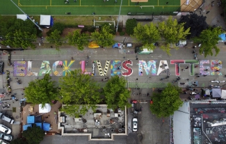 aerial photo of street with Black Lives Matter written on pavement