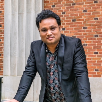 photo of man with brick building background