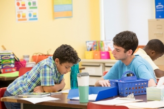 photo o f student with school children, classroom