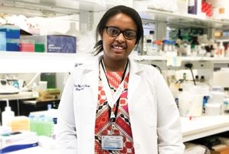 woman in white coat in lab