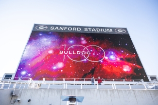 photo of stadium Jumbotron with Bulldog 100 graphic