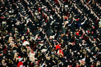 photo of seated people in caps and gowns