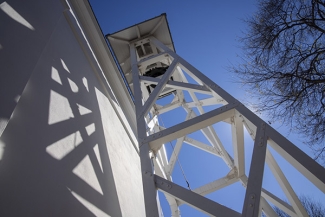 photo of bell tower and blue sky from below