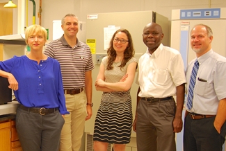 photo of four people in a lab