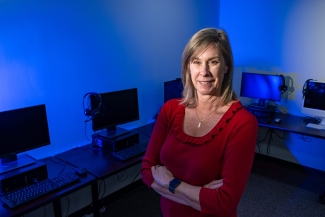 photo of woman, computer lab in background