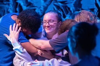 photo of people hugging central figure