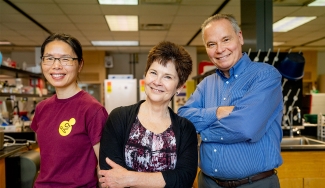 photo of three people in a laboratory 