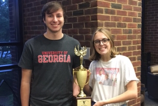 man and woman with trophy