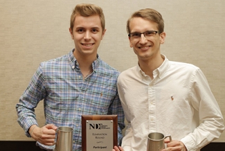 photo of two men with plaque and steins 