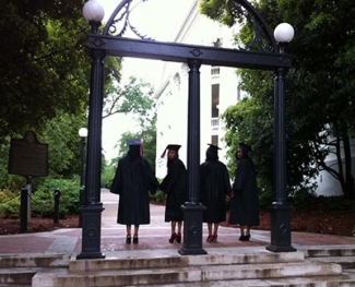 caps and gowns at the arch