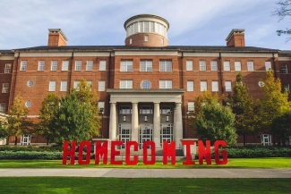 photo of building with large red letters spelling homecoming