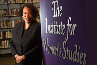 photo of woman with wall and books