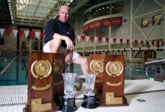 photo of many with trophies and plaques, with pool