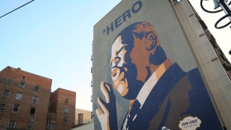 photo of a mural of man painted on side of a building