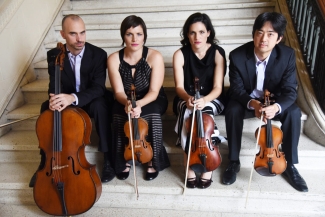 photo of four musicians seated on steps