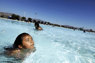 photo of woman and child in pool, day