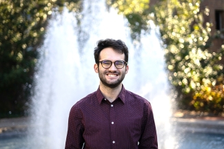 photo of man in front of fountain, day