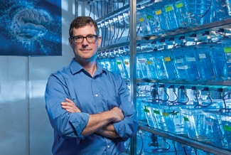 man in lab with blue lights