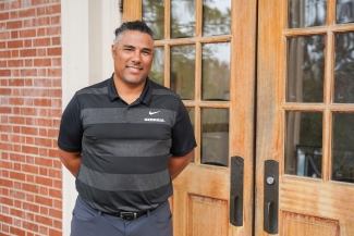 photo of man in front of double doors