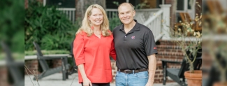 photo of two people, outdoors, steps and porch in background