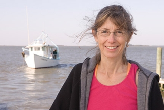 woman outside with water, boat