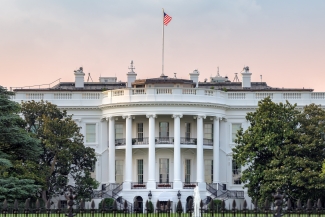 photo of U.S. White House, with flag, day