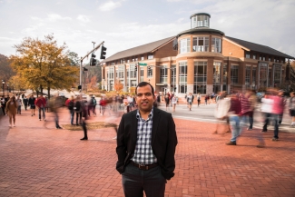 Photo of man with blurred crowds, street, in background