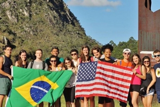 photo of students holding Brazilian and American flags