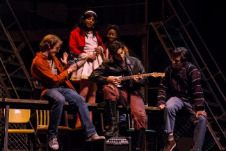 photo of five actors on stage in performance 