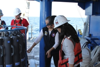 photo of five people with sensor gear on boat, ocean in background, day