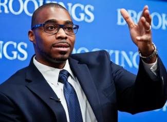 photo of man gesturing, blue background