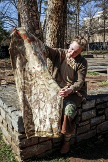 pho too woman holding eco-print fabric, outside, day