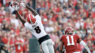 football player stretching for a catch