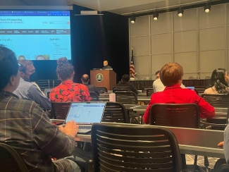 photo of conference and speaker at podium