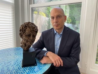 photo of man with bust sculpture