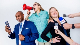 photo of man and two women, microphones, 