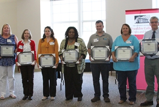 7 people with award plaques