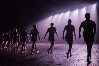 line of dancers on stage, with lights - photo from upstage