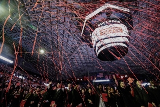 photo of indoor commencement ceremony celebration, with streamers