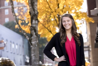 photo of woman outdoors with tree and fall foliage