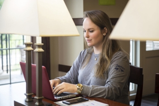 photo of woman typing on laptop computer