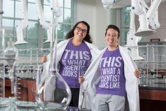 photo of women in lab coats and t-shirt in a lab