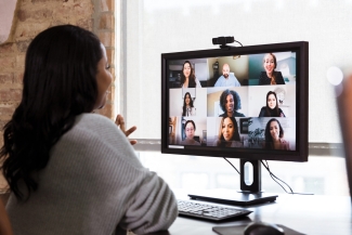 photo of woman looking at computer screen with faces