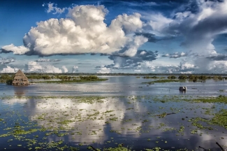 photo of flooded river, with clouds, day