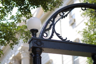 photo of architectural detail of arch, day, with trees in background