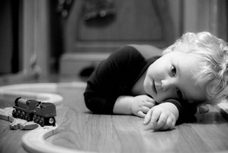 child in b/w with trains 